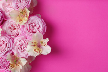 Fresh flowers on color background, top view with space for text
