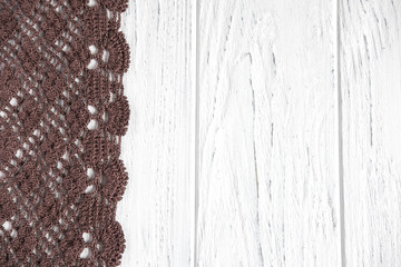 Background for greeting card with lace. Wooden background with knitted lace. Frame for text with...