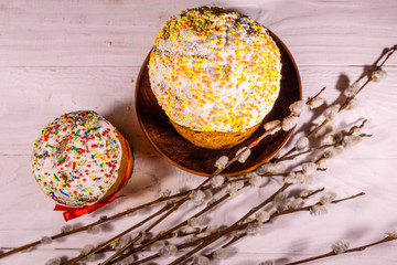 Ukrainian easter bread kulich and pussywillow branches on a white wooden table