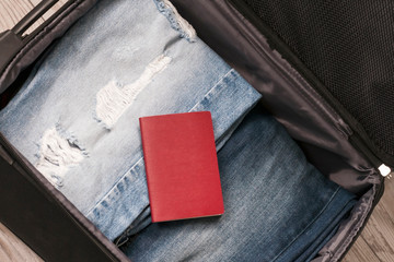 Travel concept. Jeans, card and passport In the suitcase Selective focus.