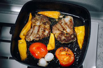 meat and vegetables fried in a pan