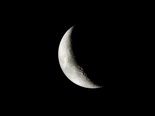 Crescent Moon / The Moon as it appears early in its first quarter or late in its last quarter, when only a small arc-shaped section of the visible portion is illuminated by the Sun