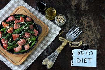 Green beans with bacon in a cast iron skillet. Healthy eating concept. Keto diet. Pegan diet. Paleo...