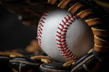 macro of Baseball at the tip of the mitt