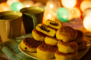 cheese pancakes with chocolate and green tea in a festive atmosphere