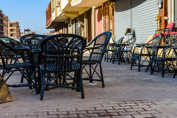 Empty tables and chairs in a street cafe