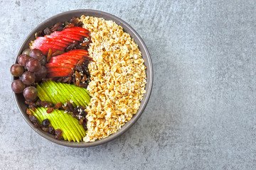 Vegan breakfast bowl of oatmeal, sesame and fruit.