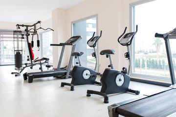 Gym interior and exercise equipments. Apartment gym studio saloon interior