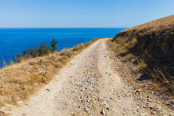 Serpentine road on the peninsula against the blue sea