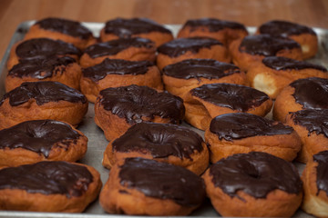 A tray of chocolate frosted doughnuts