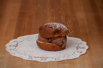 Ice Cream Doughnut being Sprinkled with Powdered Sugar