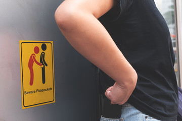 women are careful pickpocket because she see beware pickpockets sign symbol