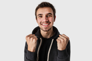 Happy caucasian young man looking into the camera. Isolated on white background.