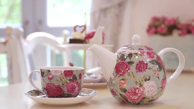 British afternoon tea set on the table with window light in background.