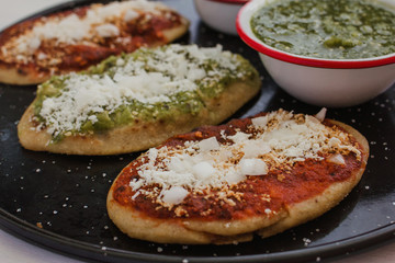 Tlacoyos Mexican food, green and red sauce in Mexico city spicy food mexican culture