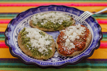 Tlacoyos Mexican food, green and red sauce in Mexico city spicy food mexican culture