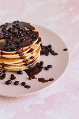 Stack of delicious homemade pancakes with sauce