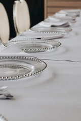 Glass clean plates on white tablecloth 