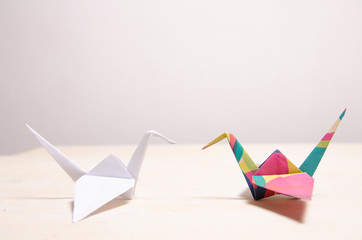 Creative concept, white origami opposite to colorful crane bird  © phoenix021