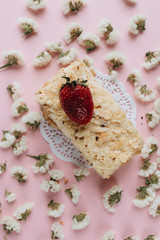 Piece of delicious fresh cake and floral petals