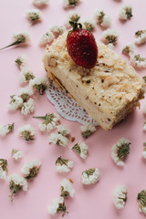 Piece of delicious fresh cake and floral petals