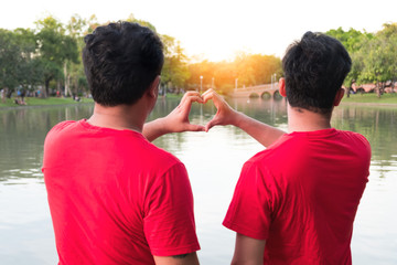 Asian gay couples Romantic Hand made heart-shaped hand to make love happily.
