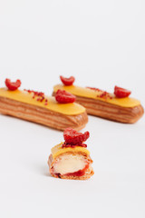 Delicious eclairs with yellow glaze, sweet dessert