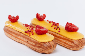 Delicious eclairs with yellow glaze, sweet dessert