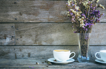Coffee cup and vase at wall.