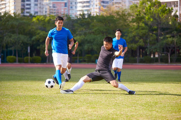 asian soccer players playing on field