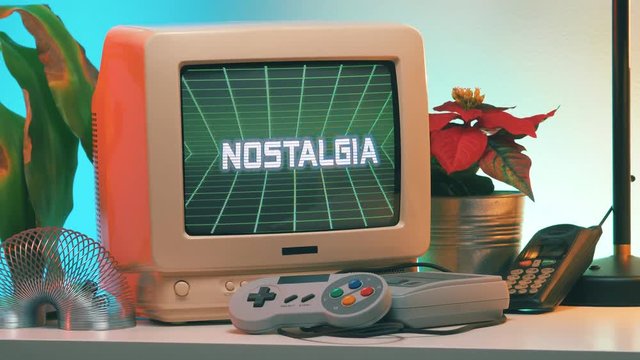 NOSTALGIA title on Old Computer - TV Screen while the camera is slightly turning around the vintage crt monitor.