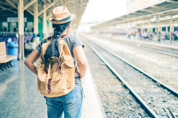 Asian woman tourist standing carrying a backpack. Wait for the train at Hua Lamphong Bangkok...