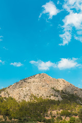 clouds over the mountains on the blue sky