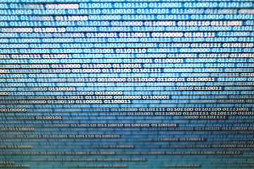 binary data on computer monitor. multiple layers of codes streaming signifying transferring...