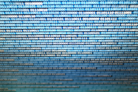 binary data on computer monitor. multiple layers of codes streaming signifying transferring information over internet medium.