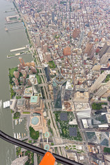 Wide-angle aerial view over World Trade Center and Tribeca, looking north towards Soho, with helicopter skid in shot