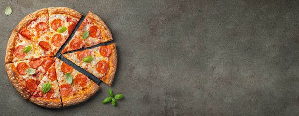 Tasty pepperoni pizza with basil. - obrazy, fototapety, plakaty