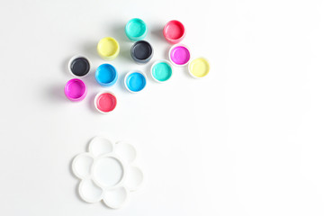 composition on white background - paints of different colors, palette and brushes. flat lay, copy...