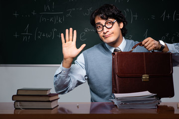Young math teacher in front of chalkboard