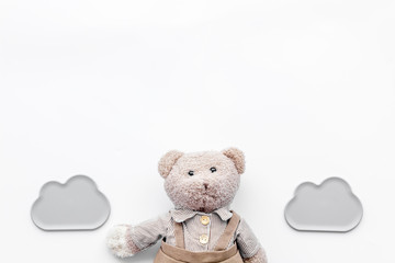 Baby care. Newborn baby concept. Baby sleep concept. Teddy bear toy near clouds on white background top view copy space