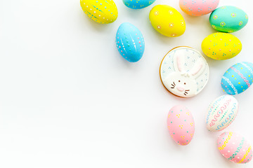Easter symbols. Colorful Easter eggs and gingerbread on white background copy space