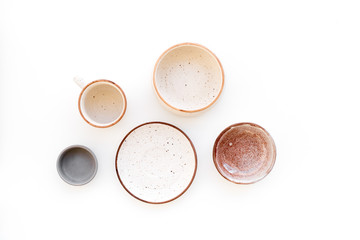 Ceramic tableware pattern. Empty plates and mugs on white background top view copy space