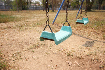 Empty chain swing in playground at park