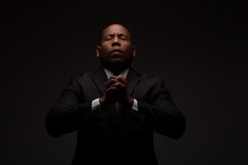 African American Christian Man Praying and Seeking Guidance from God