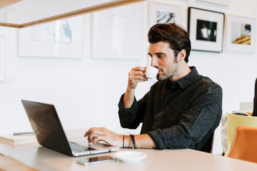 Casual man working in a cafe