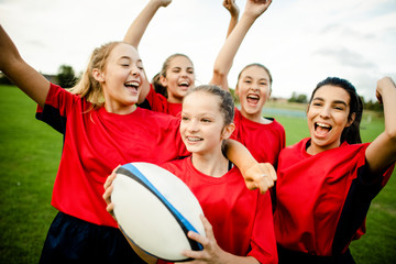 Cheerful female rugby players celebrating