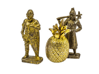 Two metal figurines of a warrior with a golden pineapple.
