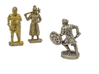Three metal figurines of a warrior.