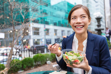 Lunch salad take out bowl healthy eating Asian business woman ready to eat in City Park living...