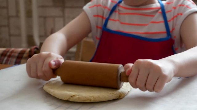 Making pizza or pide dough by close up girl hands in pastry kitchen, shaping dough is precursor to making a wide variety of food stuffs, particularly breads, biscuits, cakes, cookies, dumplings, pasta